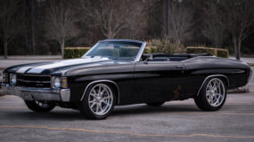 A black classic car convertible with the top down
