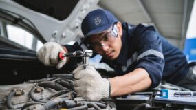 A mechanic fixing a car engine